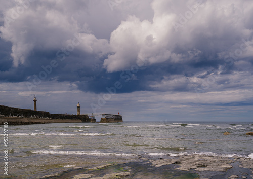 Whitby East Pier at low tide on an overcast day.