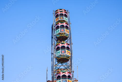 Ferris Wheel or Joint wheel ride running under blue sky on fair ground during the annual dussehra fair. photo