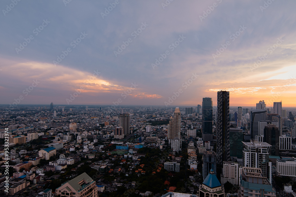 Fototapeta premium Sunset in megalopolis. Beautiful cityscape with top view on skyscrapers. Bangkok, Thailand.