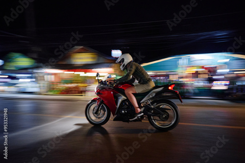 Foto Night at the city. Man riding motocycle.