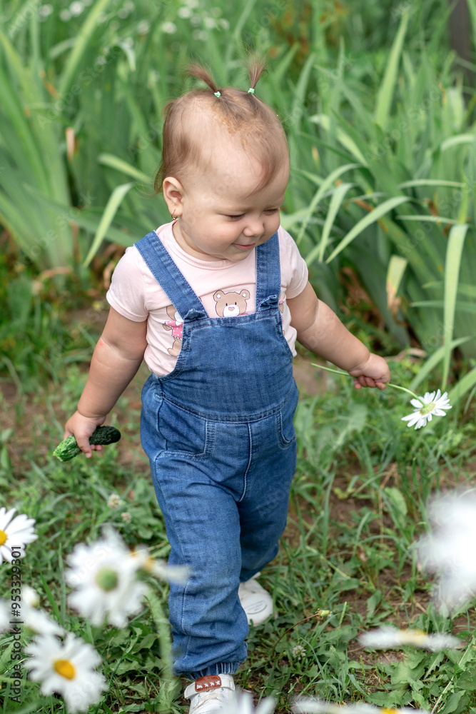 Little girl smelling chamomile flowers. Selective focus. Little girl smelling chamomile flowers. Selective focus.