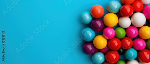 Colorful gumballs arranged on a vibrant blue background. Perfect for candy, sweets, and playful themes. photo