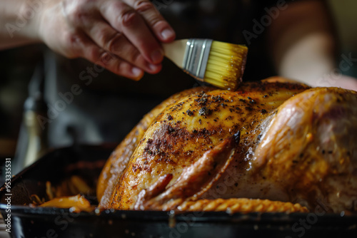 Chef basting a roasted turkey in a pan, using a brush to glaze it with juices