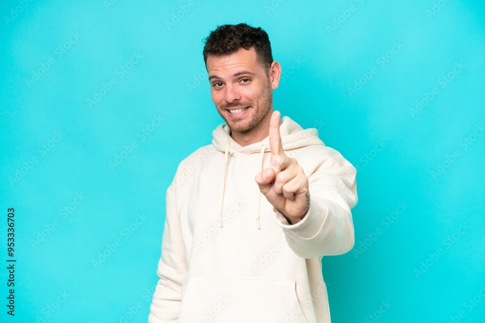 Young caucasian handsome man isolated on blue background showing and lifting a finger Young caucasian handsome man isolated on blue background showing and lifting a finger