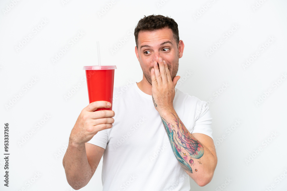 Young caucasian soda holding soda isolated on white background with surprise and shocked facial expression Young caucasian soda holding soda isolated on white background with surprise and shocked facial expression