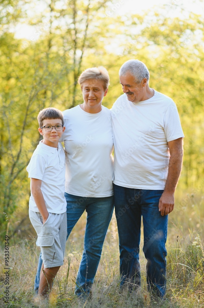 Grandparents and grandson together in autumn park Grandparents and grandson together in autumn park