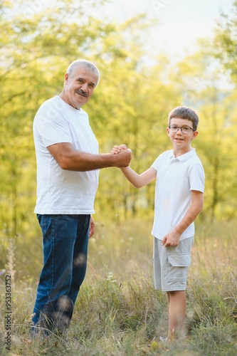 Happy weekend concept. happy grandfather and grandson are walking in the park