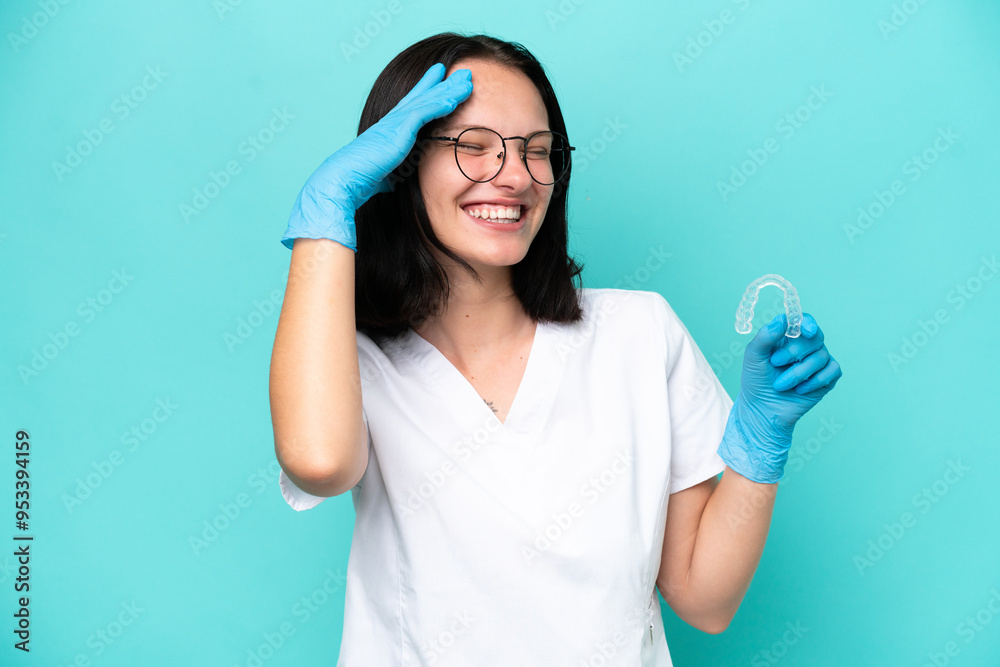 Young caucasian woman holding envisaging isolated on blue background smiling a lot Young caucasian woman holding envisaging isolated on blue background smiling a lot