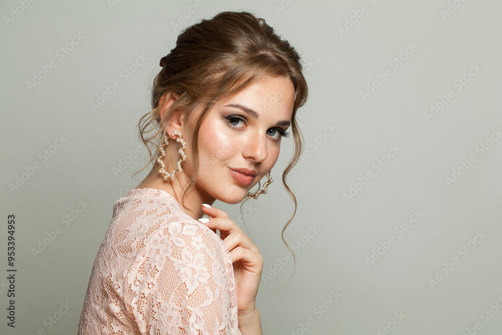 Gorgeous adorable woman wearing pink lace blouse. Model with make-up and updo hair, beautiful hairdo Gorgeous adorable woman wearing pink lace blouse. Model with make-up and updo hair, beautiful hairdo