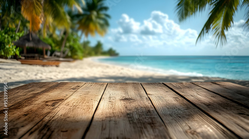 Wooden plank tabletop on a tropical beach with a blurry background of palm trees, white sand, and a turquoise ocean.