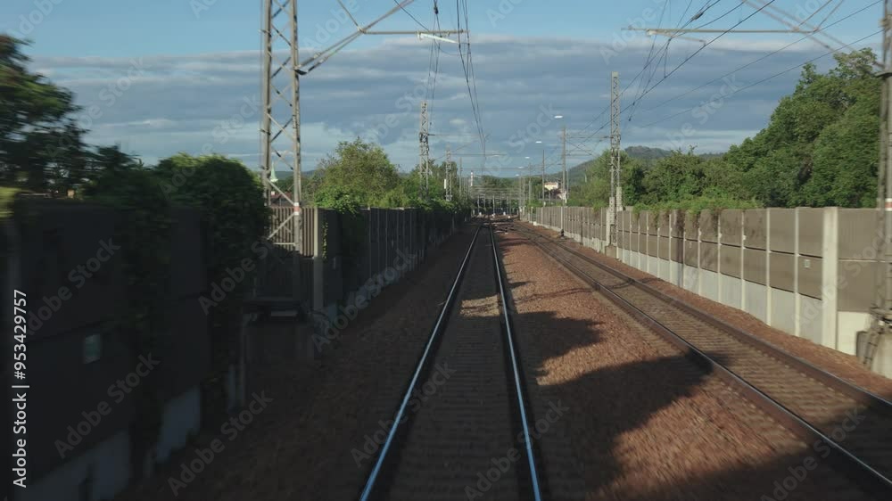 First-person perspective of railway tracks from a moving train. The image emphasizes motion and journey, capturing the essence of travel, exploration. Perfect for travel-related content First-person perspective of railway tracks from a moving train. The image emphasizes motion and journey, capturing the essence of travel, exploration. Perfect for travel-related content