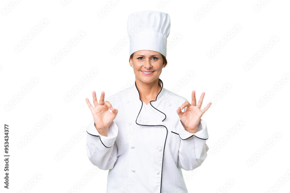 Middle-aged chef woman over isolated background showing an ok sign with fingers Middle-aged chef woman over isolated background showing an ok sign with fingers