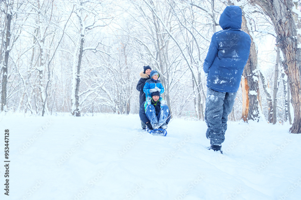 Family Winter Fun: Joyful Parents and Child Sledding Together in Snowy Forest Landscape