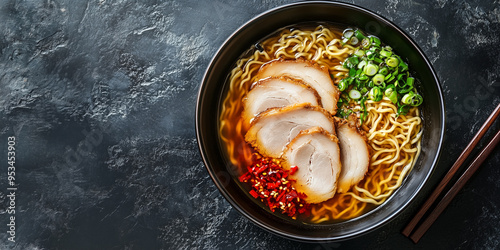 Ramen bowl with thick broth, noodles, and meat slices on a flat surface