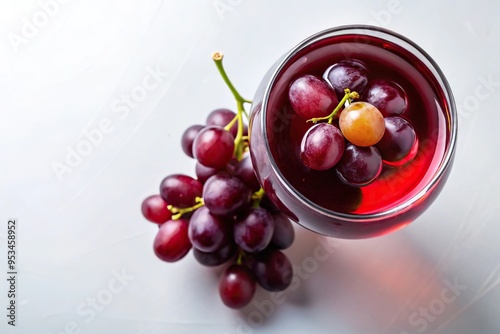 High angle shot of red wine cocktail with grape decoration on white background photo