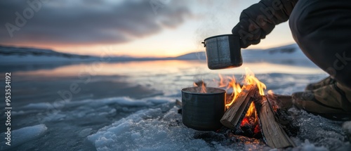 Cozy Winter Campfire by Frozen Lake at Sunset with Hot Drink and Snowy Landscape photo