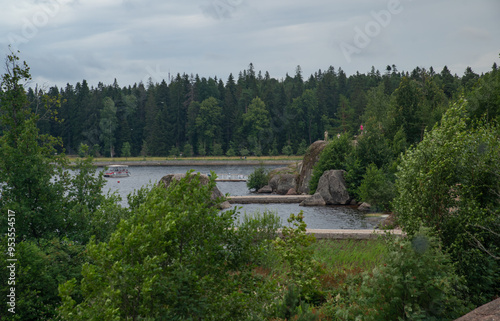 
High rocky shores above the water surface. There are mixed forests around.