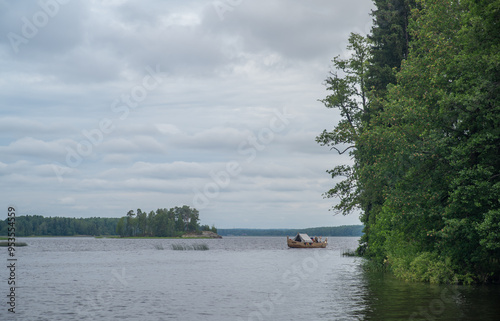 
High rocky shores above the water surface. There are mixed forests around.