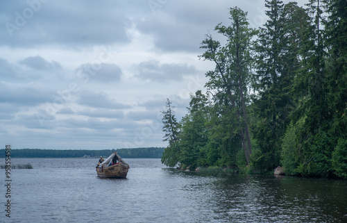 
High rocky shores above the water surface. There are mixed forests around.