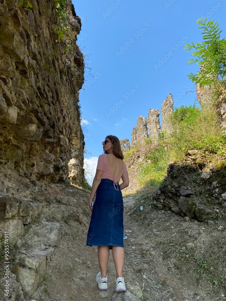 Naklejka premium young girl on an old ruins