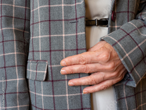 A woman holds the lapel of her jacket with her hand. The office worker listens to the client. The secretary receives instructions from the boss. Business style fashion current affairs