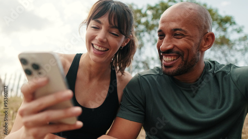 Billede på lærred A man and a woman stare at a phone screen, cuddle and discuss social media content, scroll through a newsfeed, laugh and chat