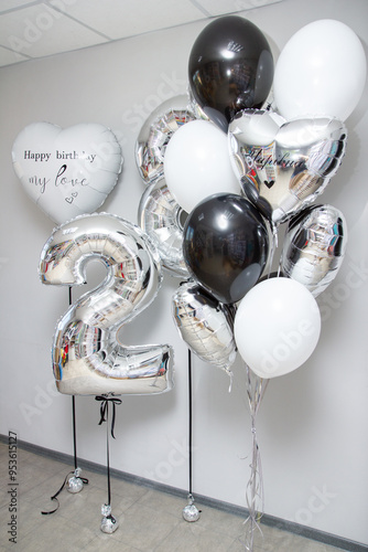 set of black and white helium balloons, silver number 28 balloons and a big white heart for your loved one