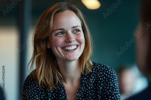 Portrait of a woman smiling at the camera in a office