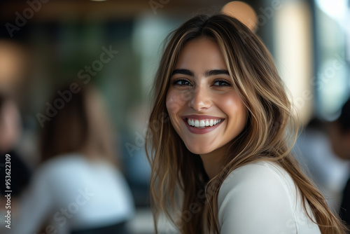 Portrait of a woman smiling at the camera in a office