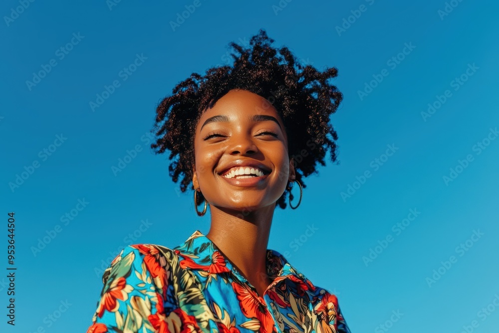 Smiling Woman in Colorful Shirt Against Clear Blue Sky Smiling Woman in Colorful Shirt Against Clear Blue Sky