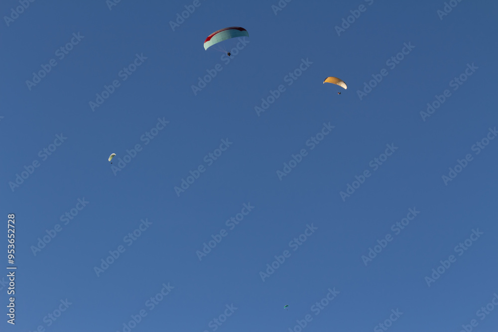 Paraplan and deltaplan in alps over a ski resort Paraplan and deltaplan in alps over a ski resort