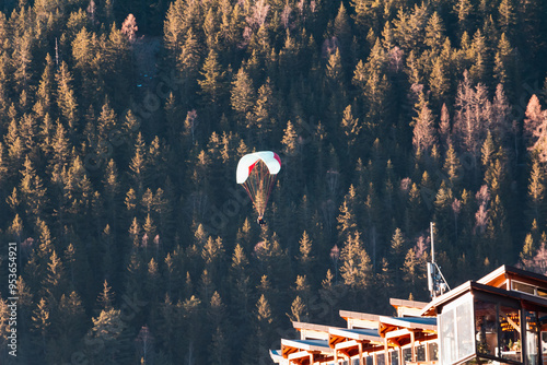 Paraplan and deltaplan in alps over a ski resort