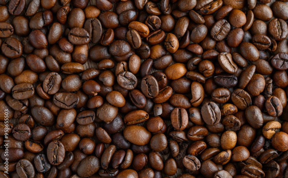 Roasted coffee beans on a flat background. Roasted coffee beans on a flat background.