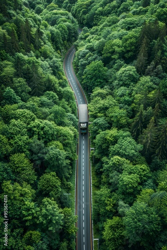 Aerial perspective of sustainable transport car and hydrogen truck on highway through green forest