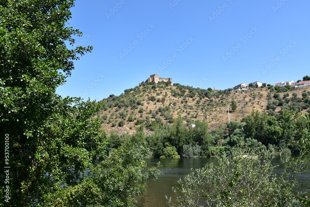 Ancient castle on a hill surrounded by a landscape of green trees and blue skies in the countryside of Portugal Ancient castle on a hill surrounded by a landscape of green trees and blue skies in the countryside of Portugal