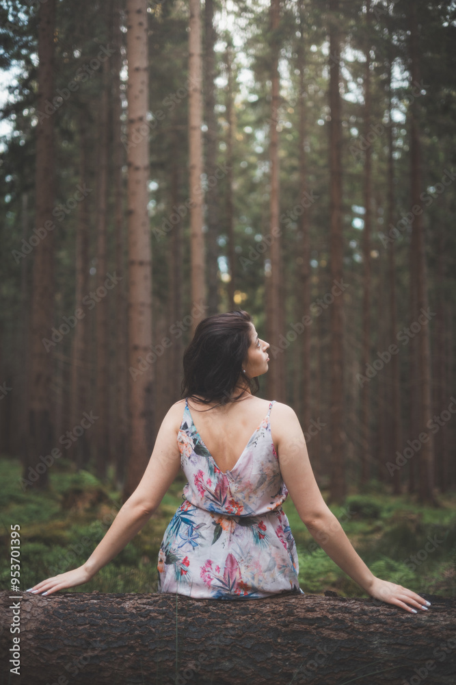 © Fauren - Pretty young brunette aged 20-25 is sitting in the forest in a colourful dress. Joy of clean air and the power of nature. Forest fairy