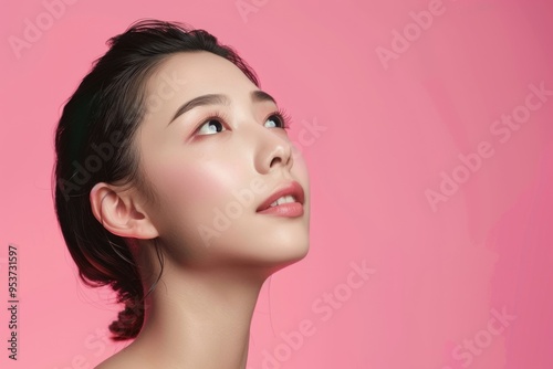 Asian woman beauty portrait with clean skin on pink background.