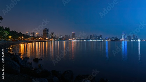 A panoramic view of the Necklace (Marine Drive) at night, with city lights reflecting on the water photo