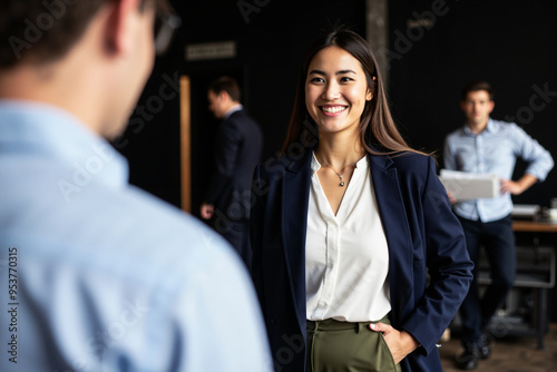 Confident businesswoman engaged in attentive conversation: Ideal for corporate training, recruitment, and diversity campaigns photo