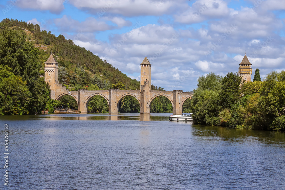 Valentré Bridge is a 14th-century six-span fortified stone arch bridge crossing the river Lot to the west of Cahors, in France. It has become a symbol of the city. Valentré Bridge is a 14th-century six-span fortified stone arch bridge crossing the river Lot to the west of Cahors, in France. It has become a symbol of the city.