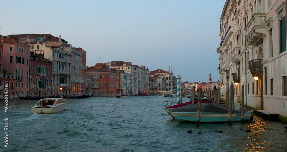 Evening stroll along the Grand Canal in Venice with scenic views of historic buildings and boats Evening stroll along the Grand Canal in Venice with scenic views of historic buildings and boats
