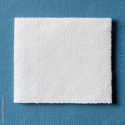 Blank white woven label tag on blue background.