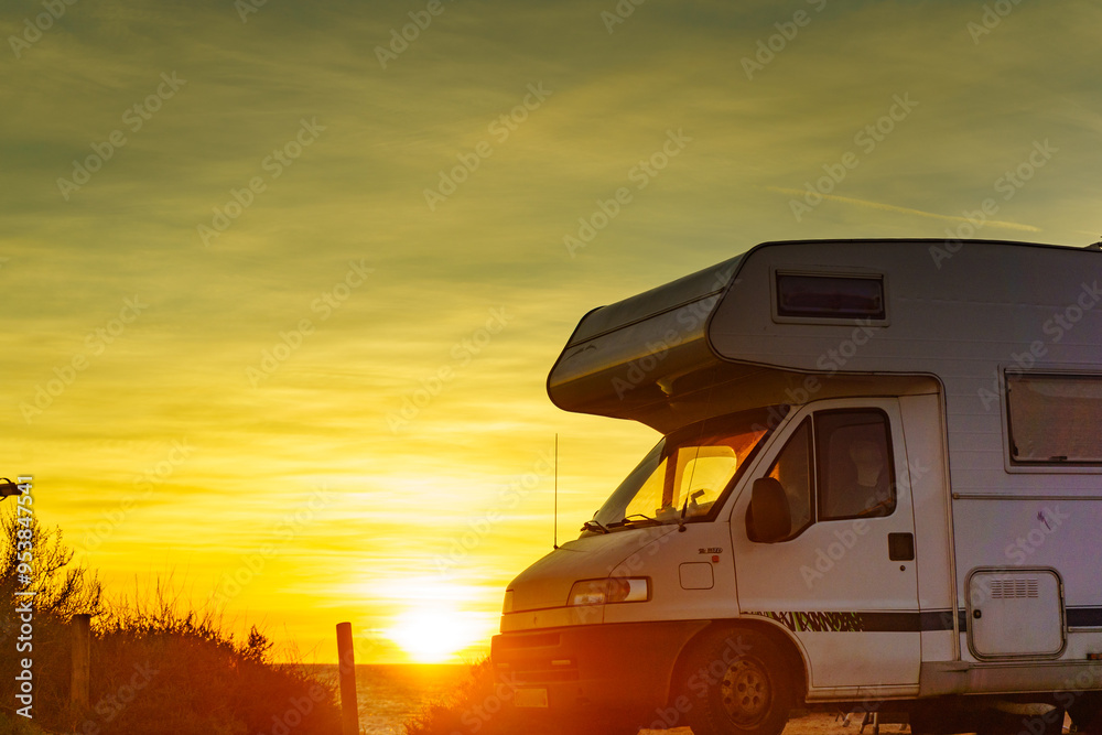 Camper car on beach at sunrise Camper car on beach at sunrise