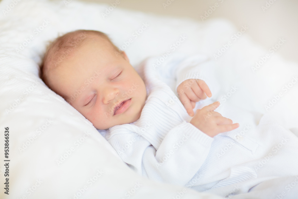 Little baby on white bed