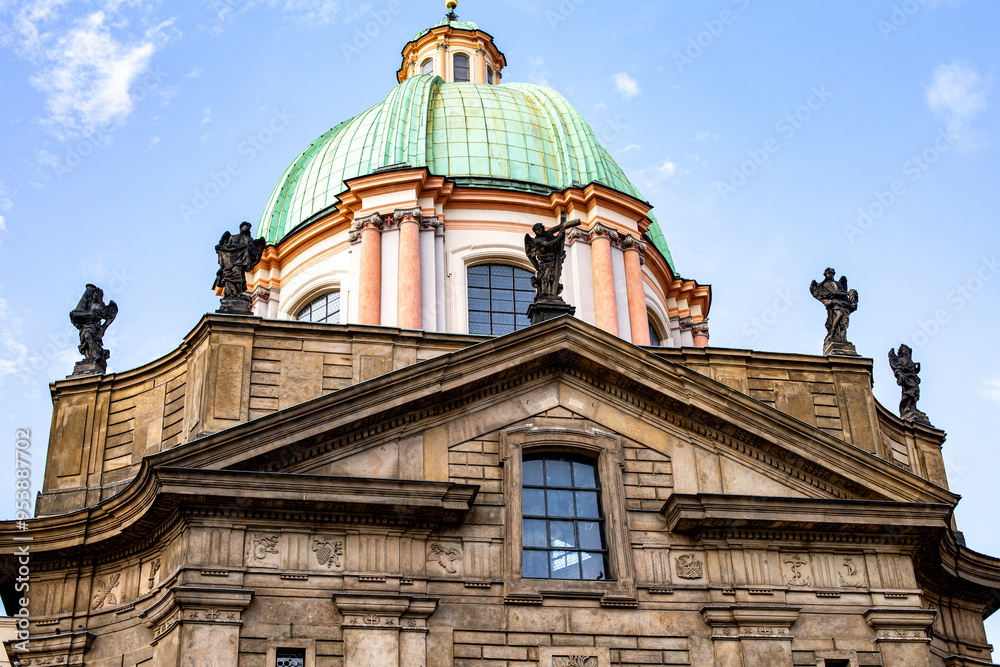 Architectural details of a historic building with a green dome and sculptures on a sunny day in an urban landscape Architectural details of a historic building with a green dome and sculptures on a sunny day in an urban landscape