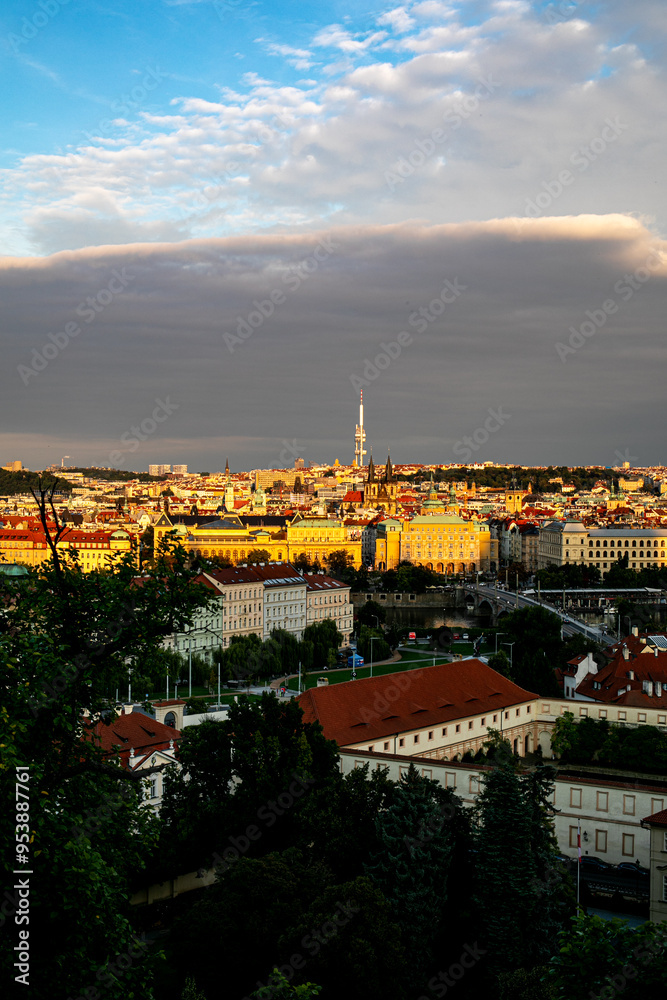 Fototapeta premium Golden light bathes the historic skyline of Ljubljana, Slovenia during the evening with clouds creating a dramatic backdrop