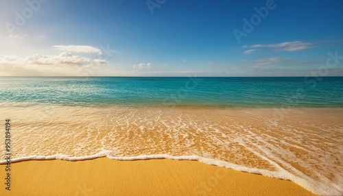 Sunny Beach With Golden Sand and Calm Waves Under Bright Blue Sky Midday photo