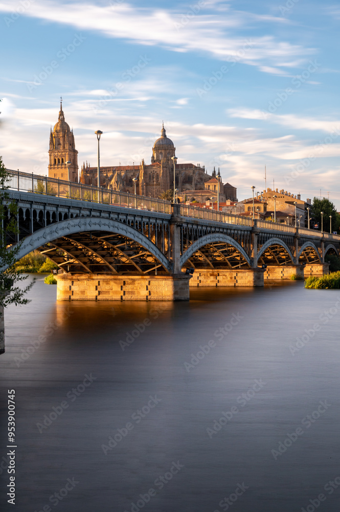 Obraz premium View of Salamanca (Spain) at sunset, with the cathedral and the Enrique Estevan bridge from the viewpoint of the pier on the Tormes river