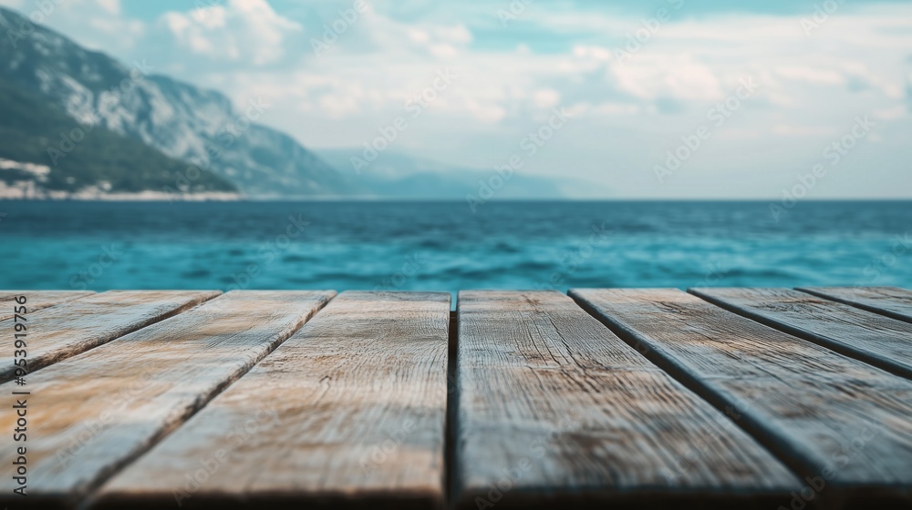 Fototapeta premium Closeup shot of a wooden table with sea in the background.