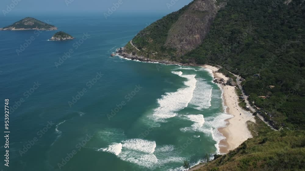 Aerial view of Prainha Beach, a paradise in the west side of Rio de Janeiro, Brazil. Big hills around. Sunny day. Greenish sea. Drone take. Aerial view of Prainha Beach, a paradise in the west side of Rio de Janeiro, Brazil. Big hills around. Sunny day. Greenish sea. Drone take.